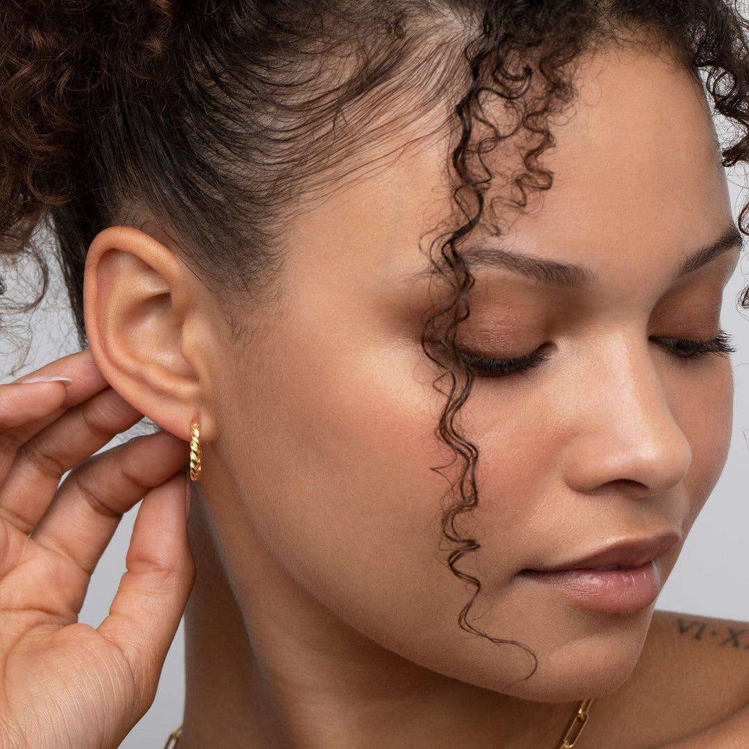 The Dainty Twisted Hoop Earrings styled in 18K Gold Vermeil — elegant everyday jewelry. Hypoallergenic for sensitive ears.