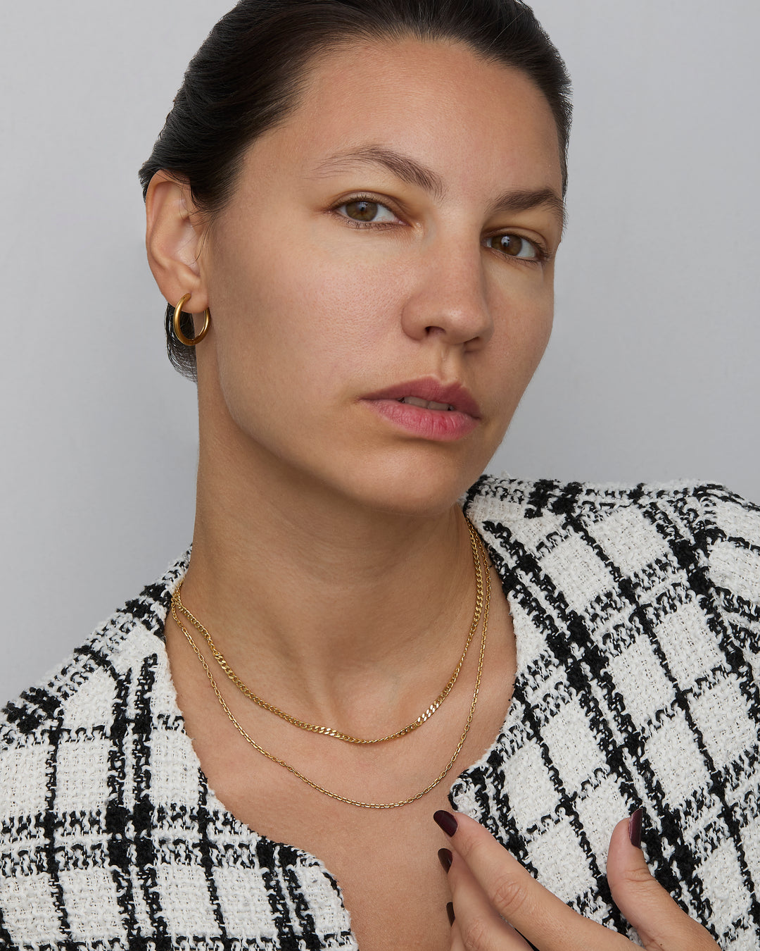 Diamond Cut Cable Chain Necklace layered with a second gold chain — layering necklace look.