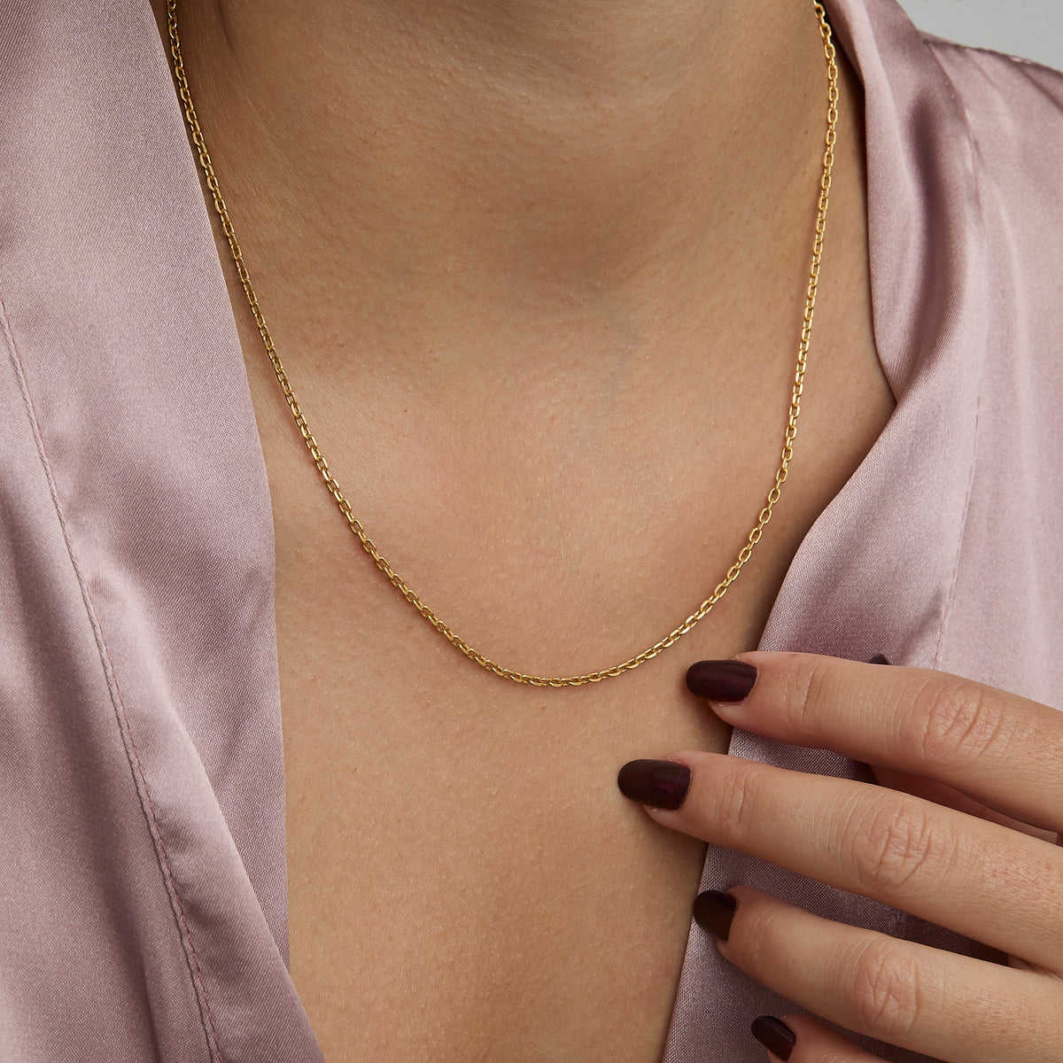 Woman wearing the 2 mm Diamond Cut Cable Chain Necklace in gold — dainty everyday chain.