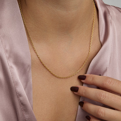 Woman wearing the 2 mm Diamond Cut Cable Chain Necklace in gold — dainty everyday chain.