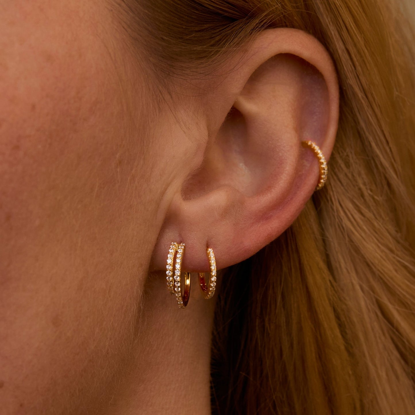 Macro detail of the Double Hoop Pavé Earring Set: CZ Diamond set in 18K Gold Vermeil. No green marks, handmade jewelry.