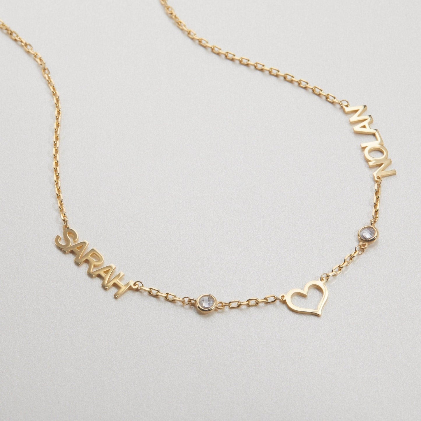 Macro detail of the Double Name Necklace with Birthstone: Birthstone set in 18K Gold Vermeil. Tarnish-resistant, handmade.