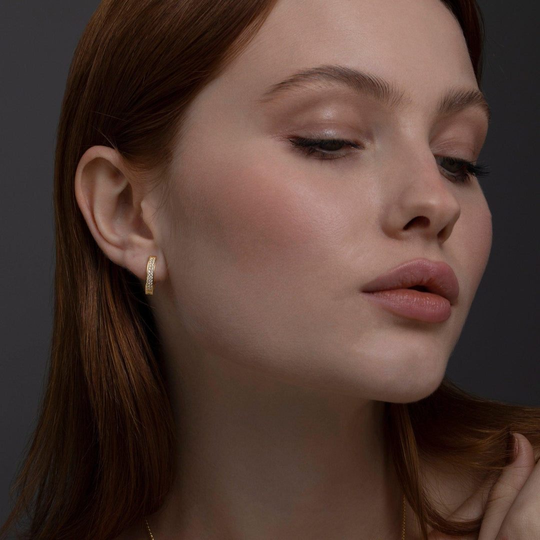 The Double Row Huggie Hoop Earring styled in 18K Gold Vermeil — elegant everyday jewelry. Hypoallergenic for sensitive ears.