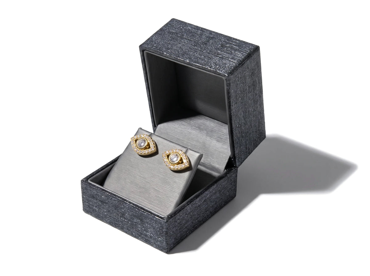 Luxury earring box with a soft grey lining, shown with stud earrings inside
