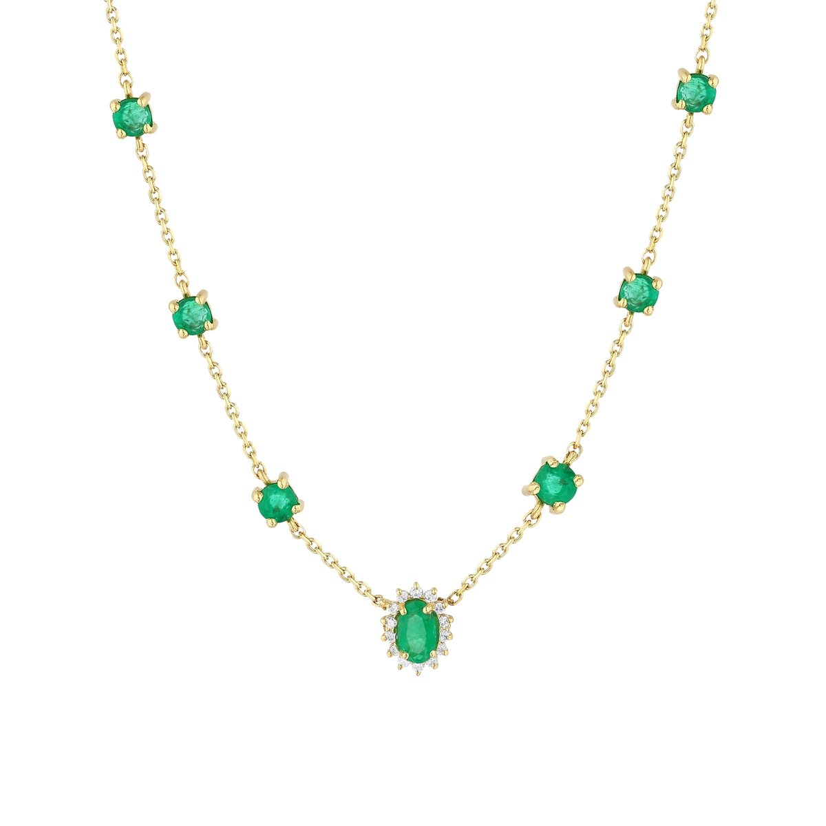 Close-up of the oval emerald in a natural diamond halo and the round emerald stations in 14K yellow gold