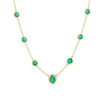 Close-up of the oval emerald in a natural diamond halo and the round emerald stations in 14K yellow gold