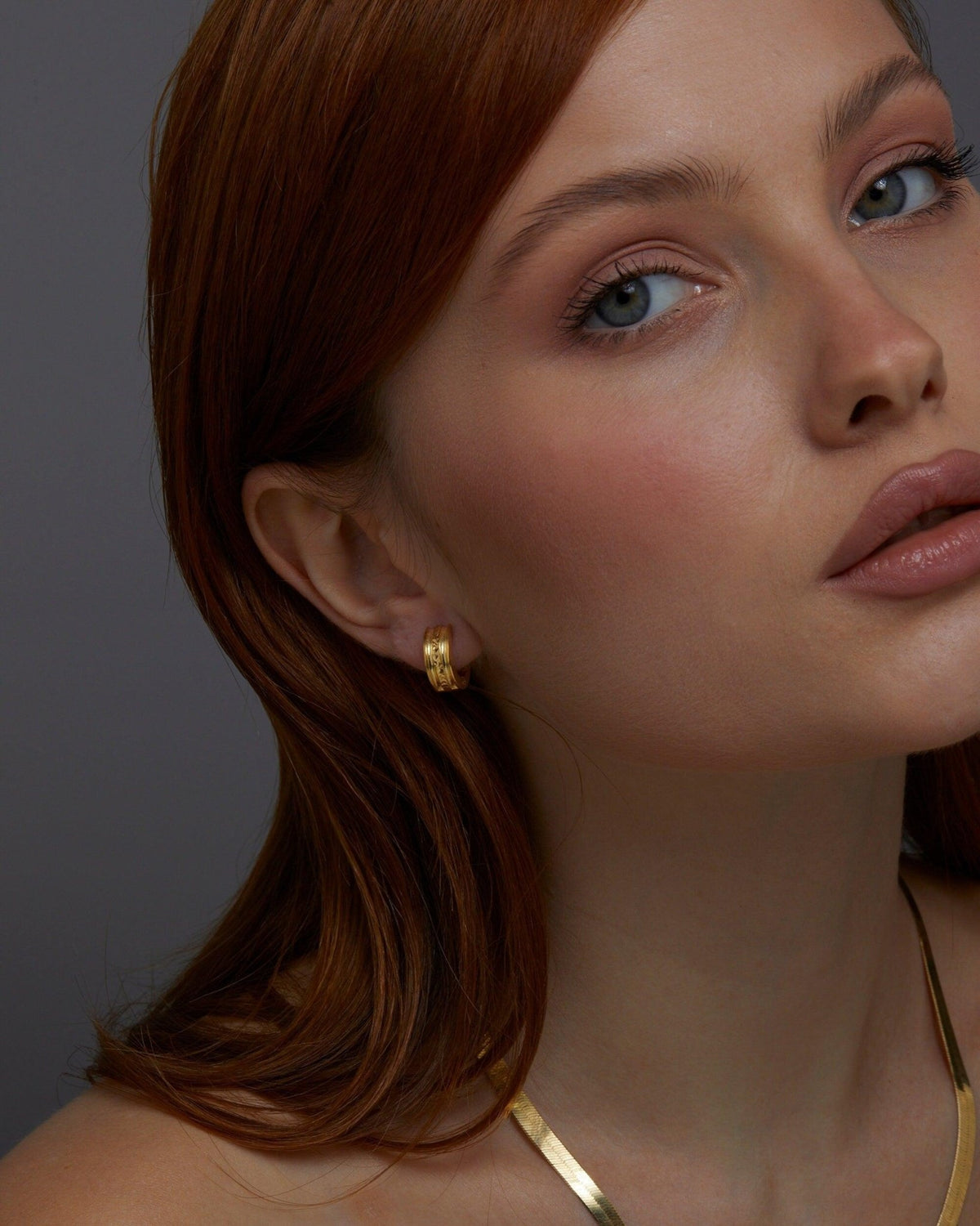 The Fashion Gold Huggie Hoop Earring worn in 18K Gold Vermeil — refined accessory for women. Tarnish-resistant.