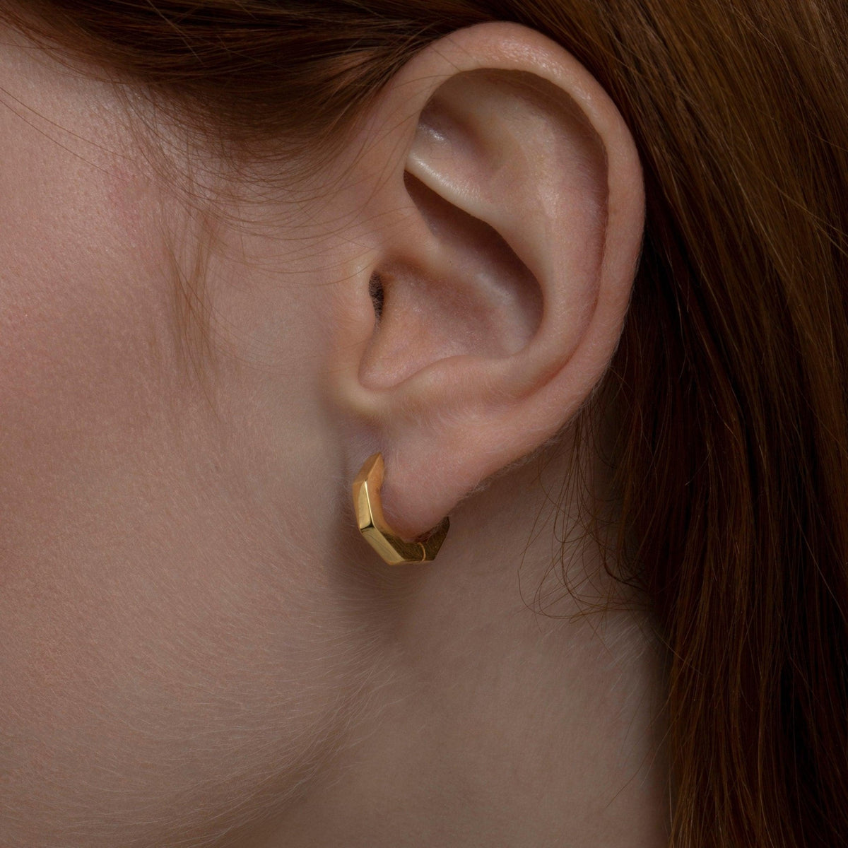 Close detail of the Geometric Hexagon Huggie Earrings in 18K Gold Vermeil. Tarnish-resistant, premium handmade jewelry.