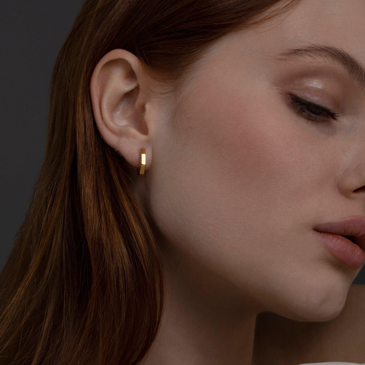 The Geometric Hexagon Huggie Earrings styled in 18K Gold Vermeil — elegant everyday jewelry. Hypoallergenic for sensitive.