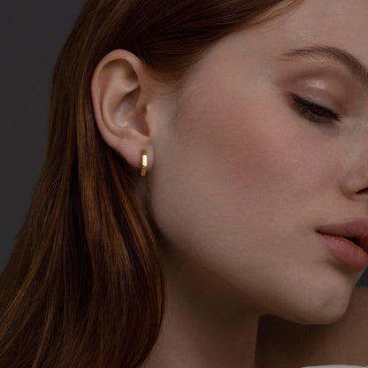 The Geometric Hexagon Huggie Earrings styled in 18K Gold Vermeil — elegant everyday jewelry. Hypoallergenic for sensitive.
