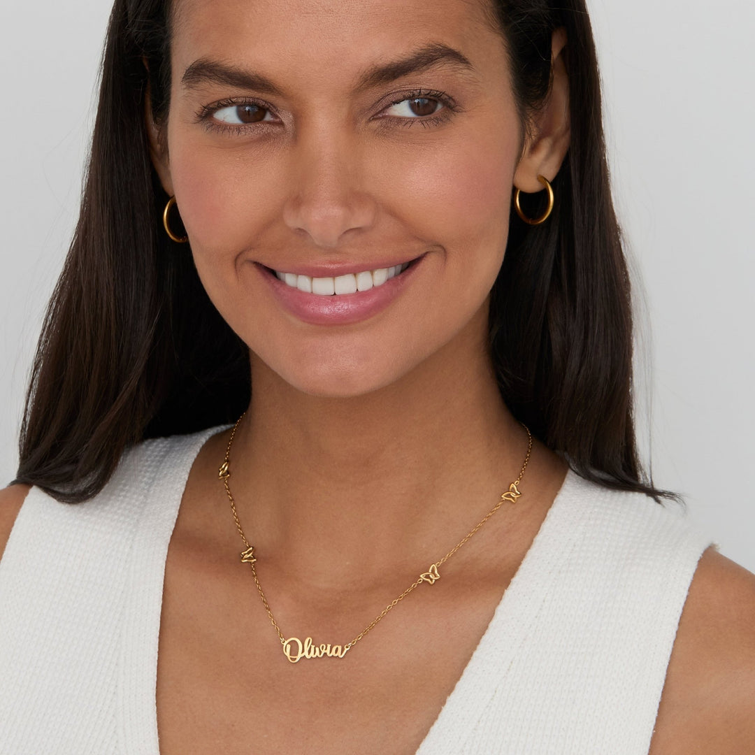Woman wearing the Gold Butterfly Name Necklace in 18K gold-plated stainless steel.