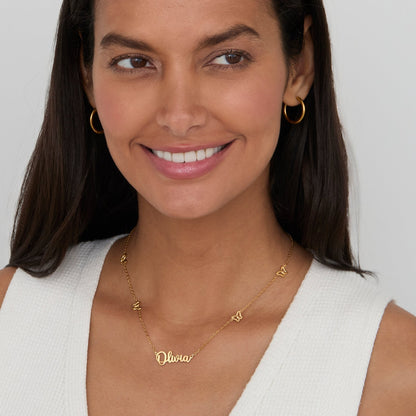 Woman wearing the Gold Butterfly Name Necklace in 18K gold-plated stainless steel.