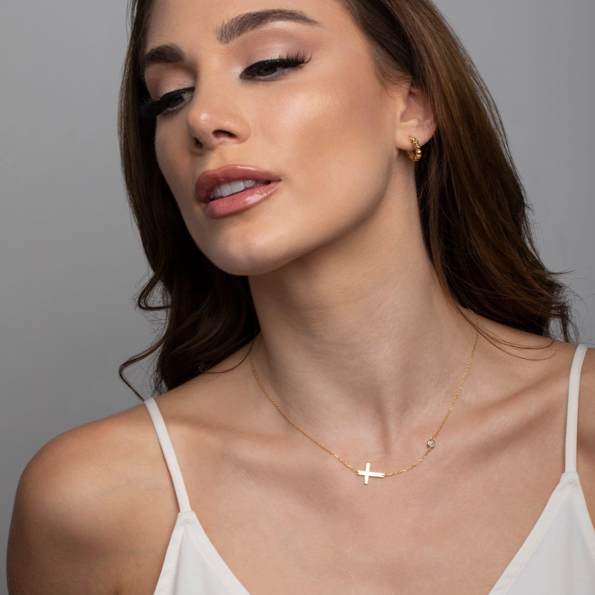 The Gold Cross Necklace with CZ Diamond styled in 18K Gold Vermeil — elegant everyday jewelry. Hypoallergenic, no green.