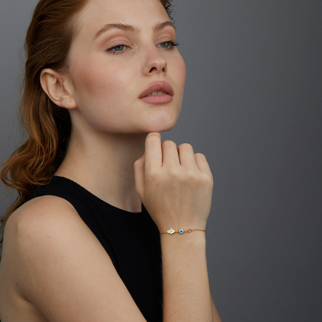 The Gold Hamsa Hand Evil Eye Bracelet as a graduation gift in 18K Gold Vermeil. Safe for sensitive skin, made for keeping.