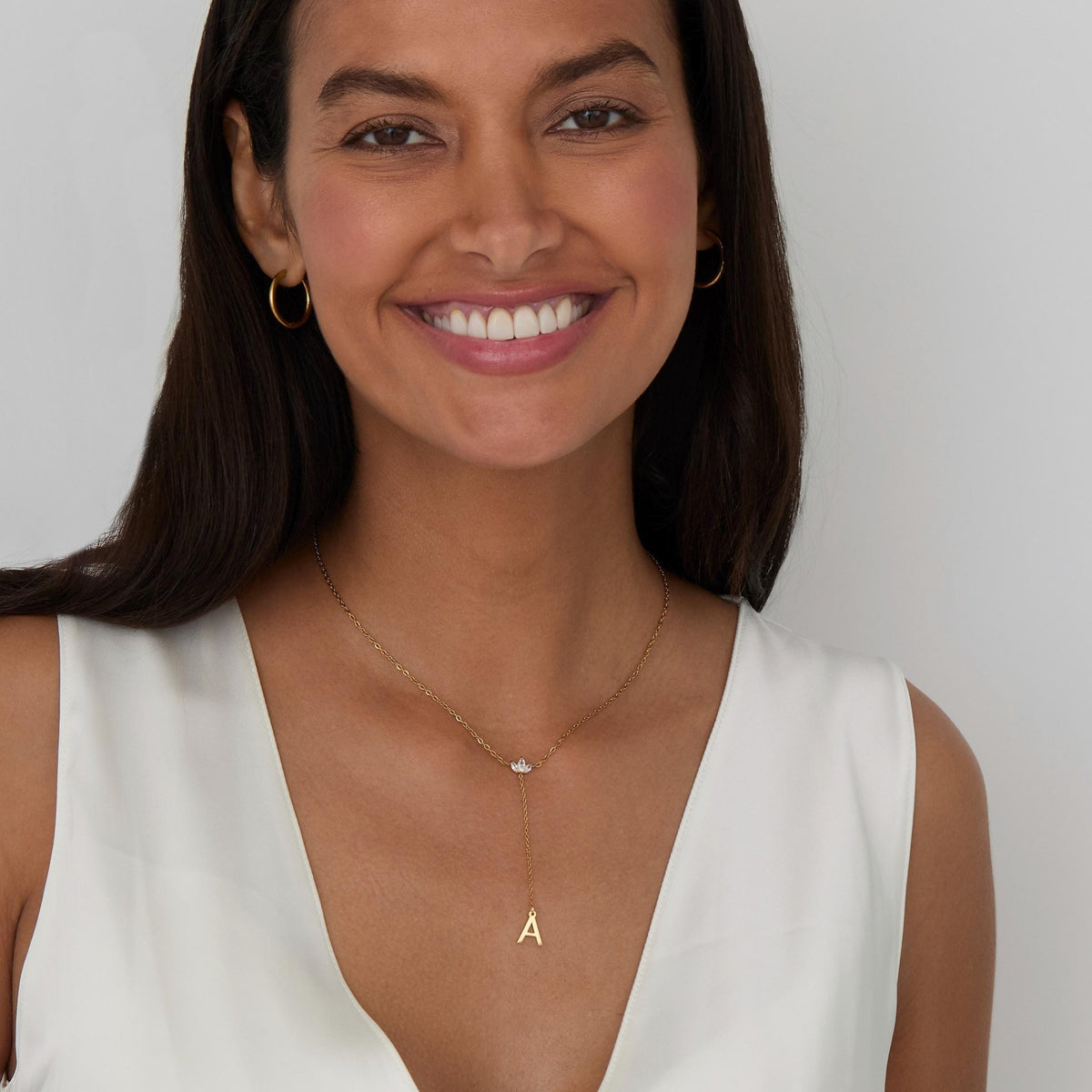 The Gold Initial Lariat Necklace styled in Gold-Plated Steel — elegant everyday jewelry. Hypoallergenic, no green marks.