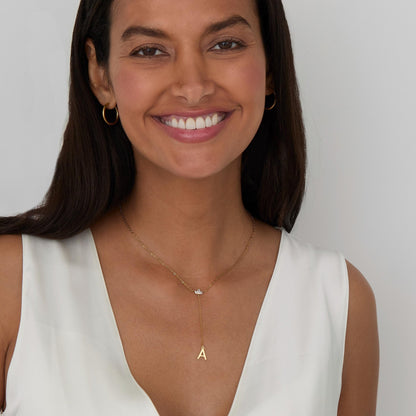 The Gold Initial Lariat Necklace styled in Gold-Plated Steel — elegant everyday jewelry. Hypoallergenic, no green marks.