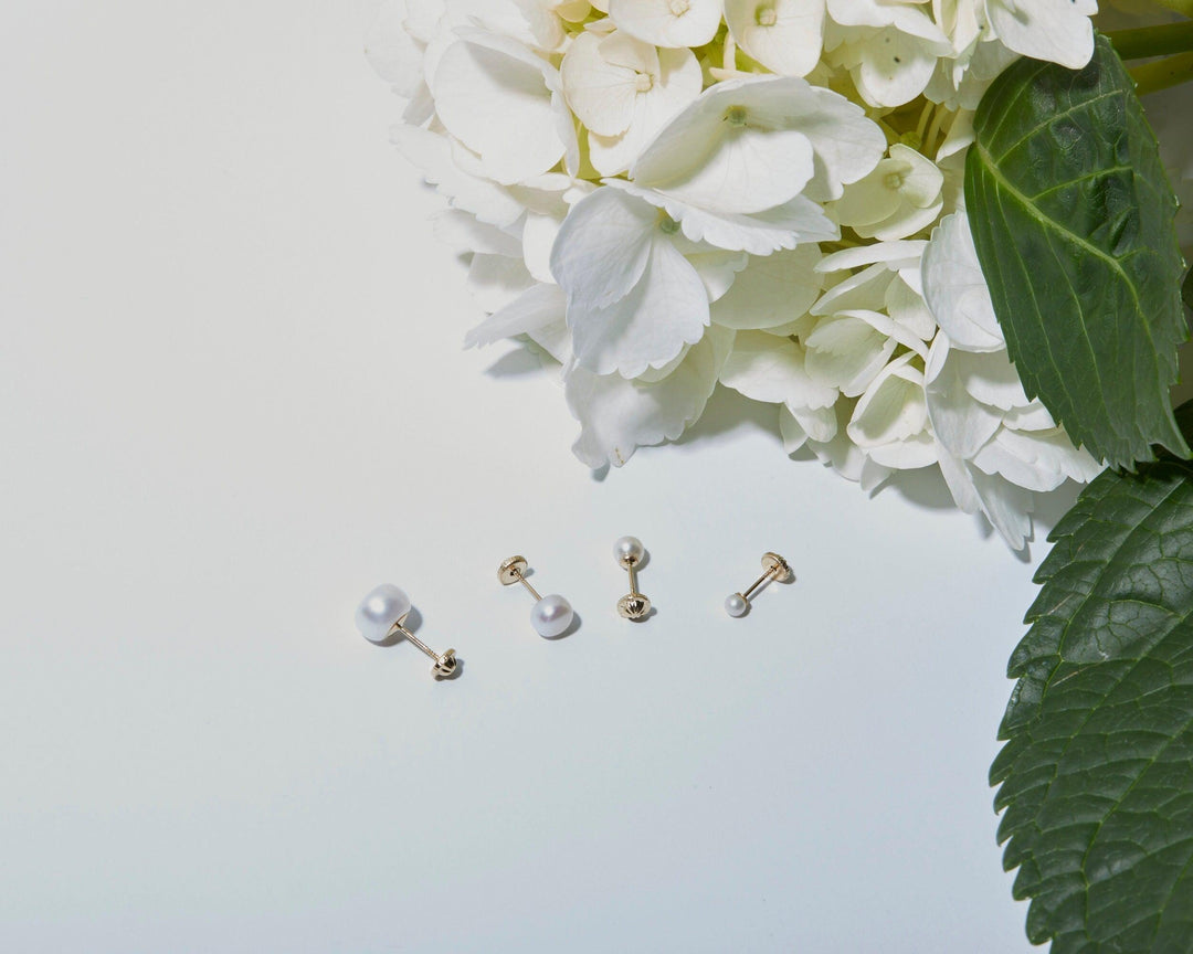 Macro detail of the 14K Gold Pearl Stud Earrings: Freshwater Pearl set in 14K Solid Gold. Solid gold luxury, handmade.