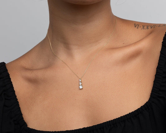 Close detail of the Gold Triple Stone Necklace in 18K Gold Vermeil with CZ Diamond. Hypoallergenic, no green marks, premium.