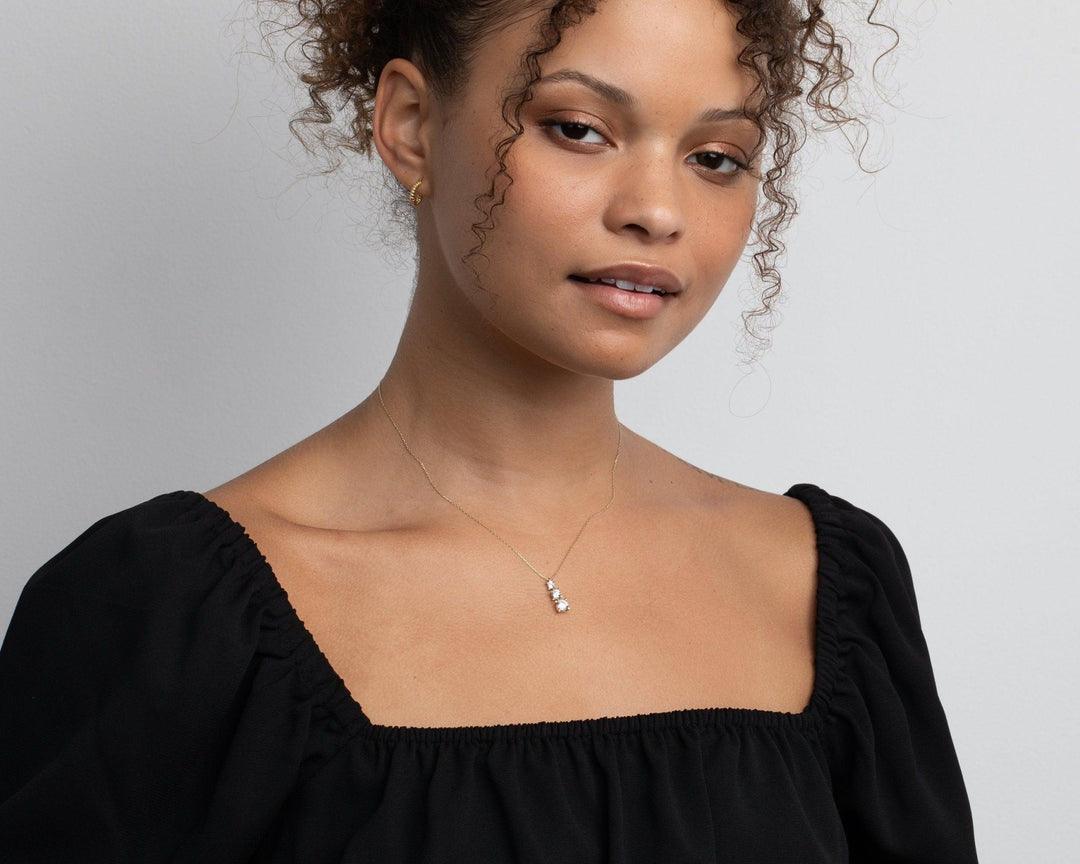 The Gold Triple Stone Necklace styled in 18K Gold Vermeil — elegant everyday jewelry. Tarnish-resistant.