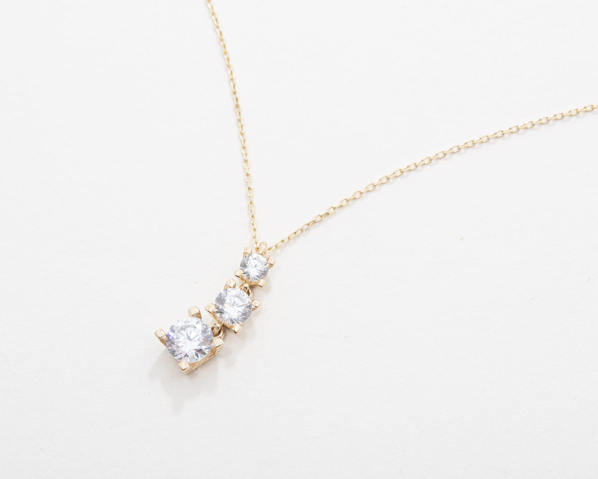 The Gold Triple Stone Necklace as an anniversary gift in 18K Gold Vermeil. Tarnish-resistant, made for keeping.