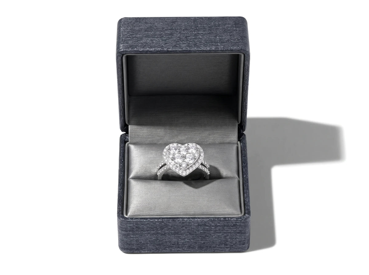 Diamond heart ring presented in a dark textured jewelry box with a soft grey lining