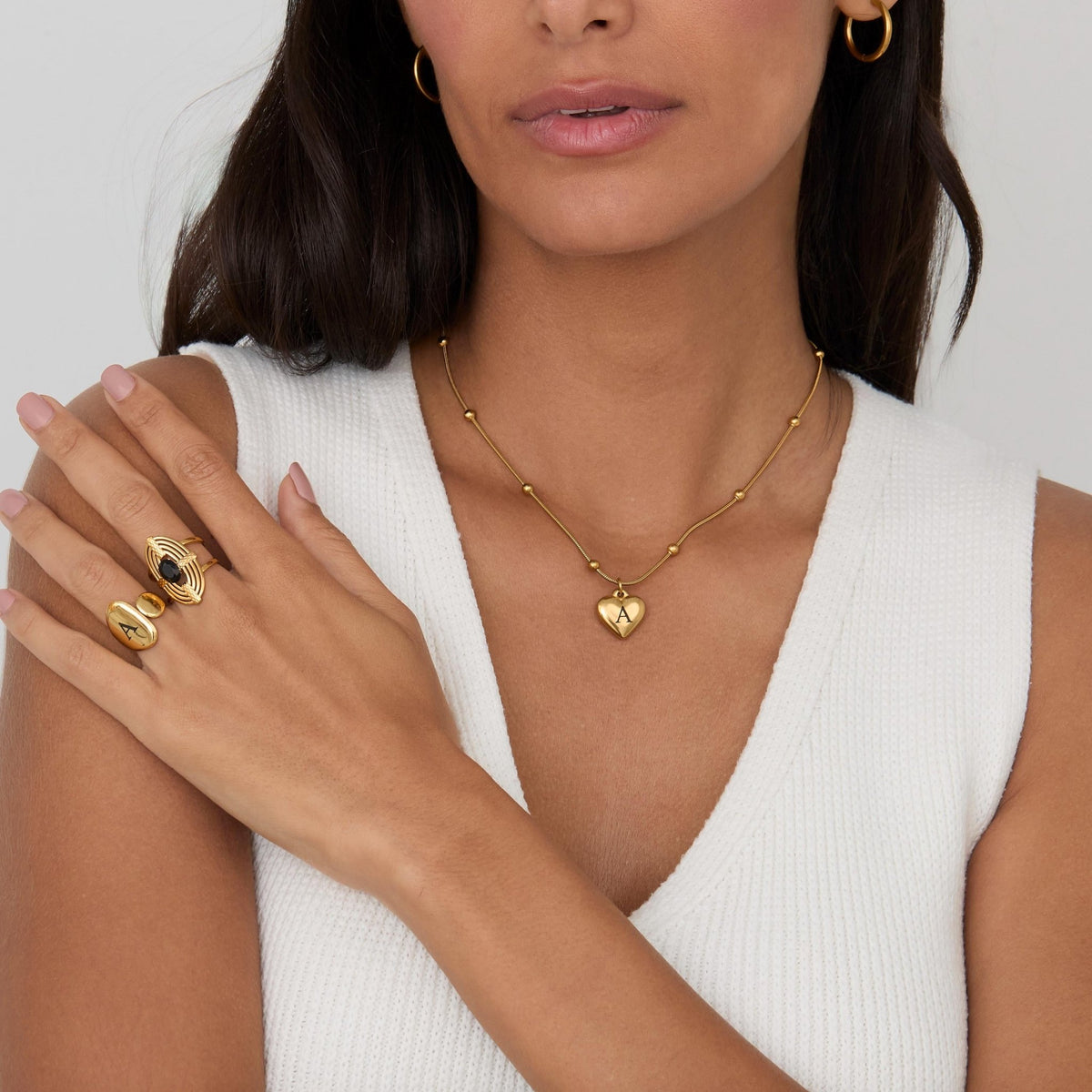 The Heart Initial Engraved Necklace worn in Gold-Plated Steel — refined accessory for women. Safe for sensitive skin.