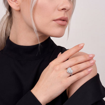 1.59 ct natural diamond heart cluster halo ring in 14K white gold worn on the ring finger, hand resting on the shoulder over a black tuxedo jacket