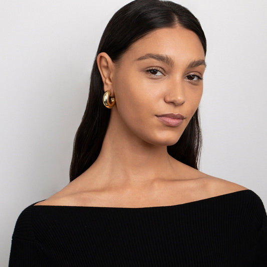 Close detail of the Hollow Chunky Hoop Earrings in Gold-Plated Steel. Tarnish-resistant, premium handmade jewelry.