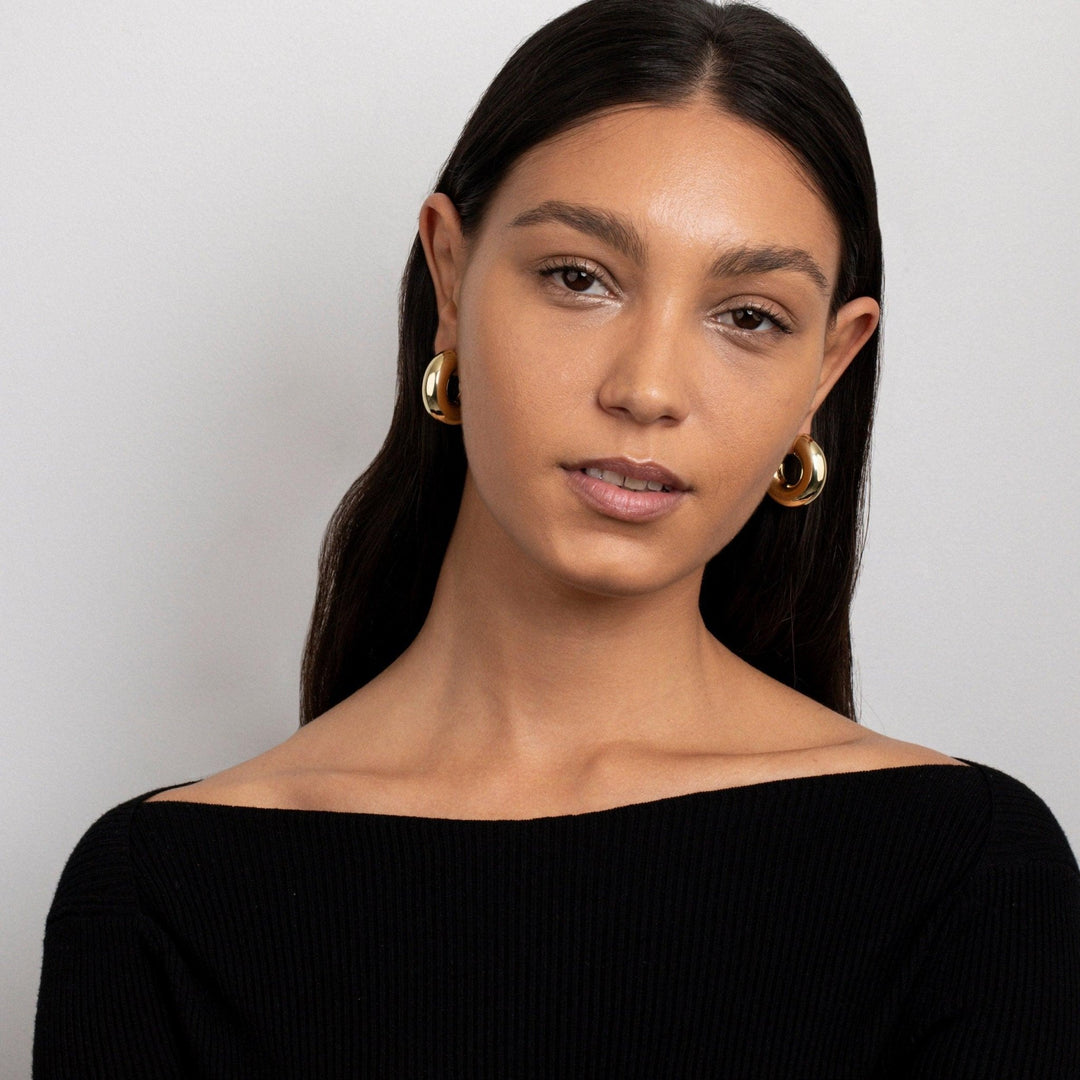 The Hollow Chunky Hoop Earrings as an anniversary gift in Gold-Plated Steel. Tarnish-resistant, made for keeping.