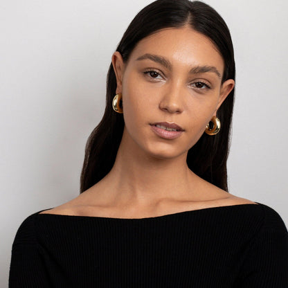 The Hollow Chunky Hoop Earrings as an anniversary gift in Gold-Plated Steel. Tarnish-resistant, made for keeping.