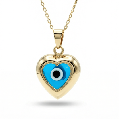 Evil eye necklace in 14K solid gold: a small gold heart framing a blue evil eye, on a gold cable chain.