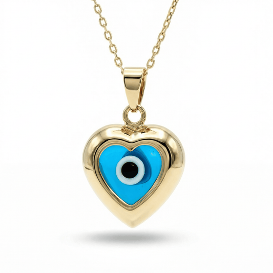 Evil eye necklace in 14K solid gold: a small gold heart framing a blue evil eye, on a gold cable chain.