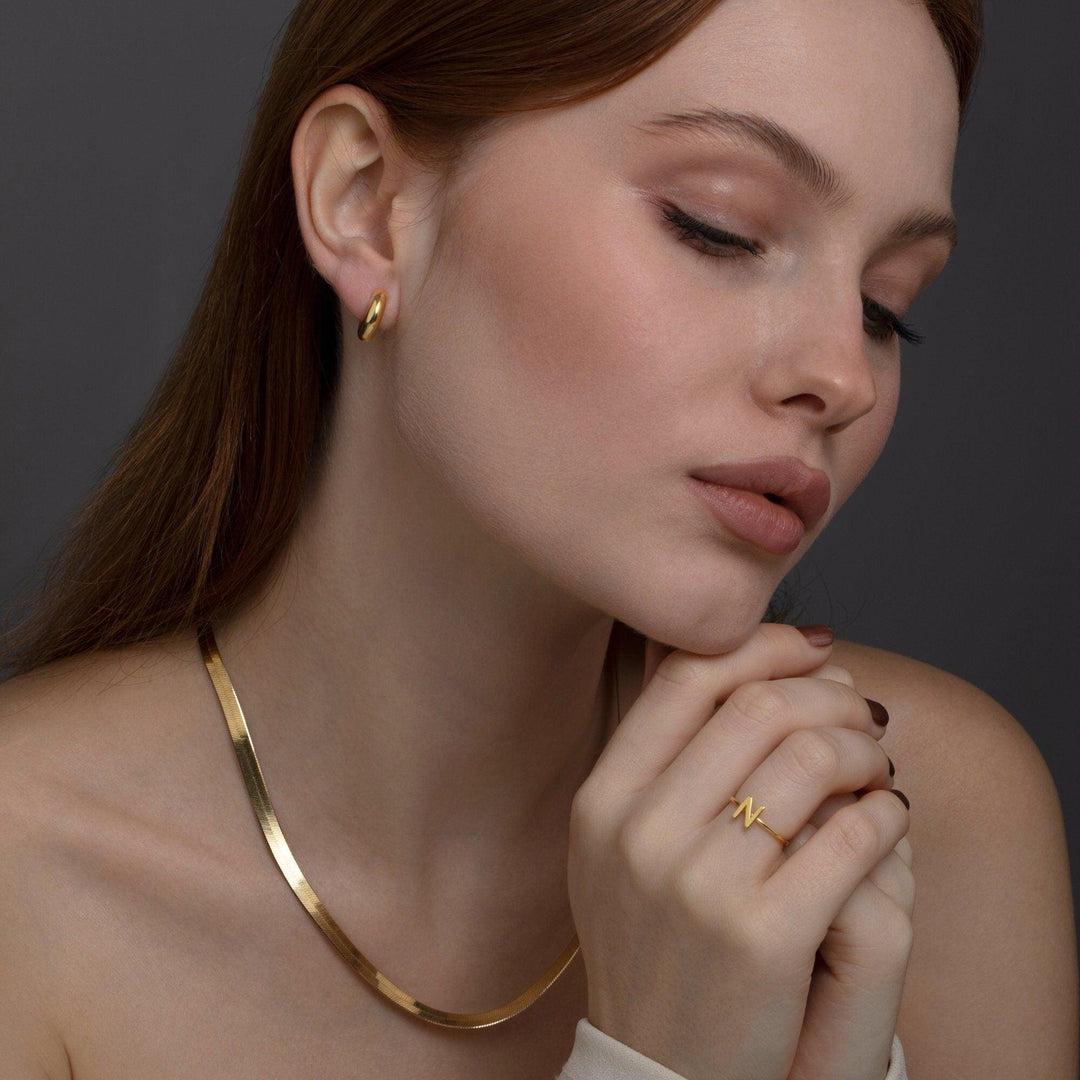 The Huggie Hoops Hinged Earrings styled in 18K Gold Vermeil — elegant everyday jewelry. Hypoallergenic for sensitive ears.