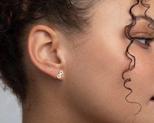 Close detail of the Infinity Earrings with CZ Diamonds in 18K Gold Vermeil with CZ Diamond. Tarnish-resistant, premium.