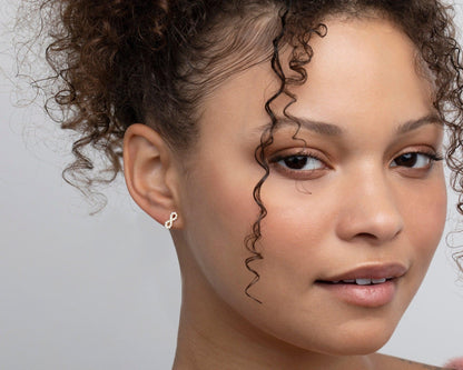 The Infinity Earrings with CZ Diamonds styled in 18K Gold Vermeil — elegant everyday jewelry. Hypoallergenic for sensitive.