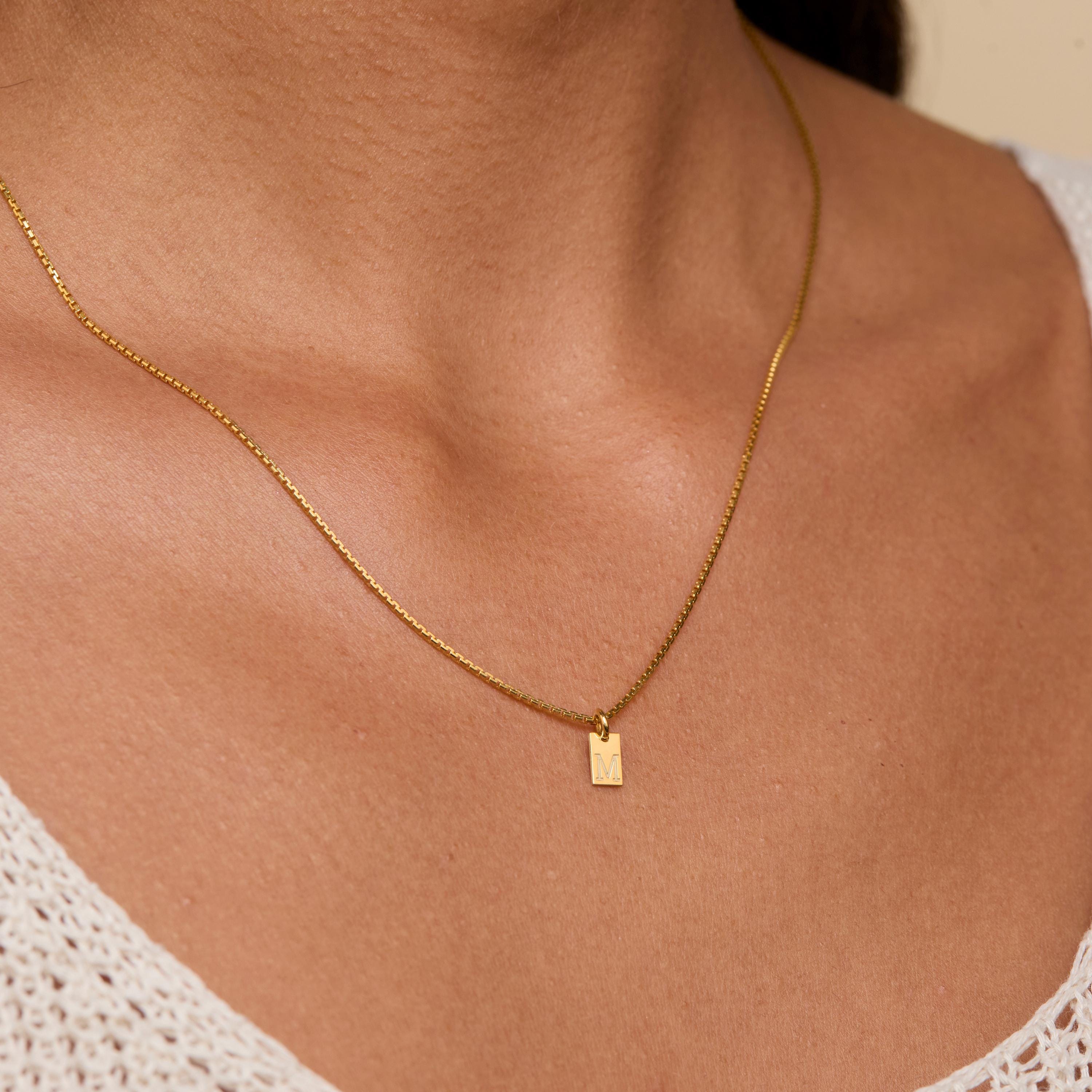The Initial Tag Necklace styled in 18K Gold Vermeil — elegant everyday jewelry. Hypoallergenic, no green marks.