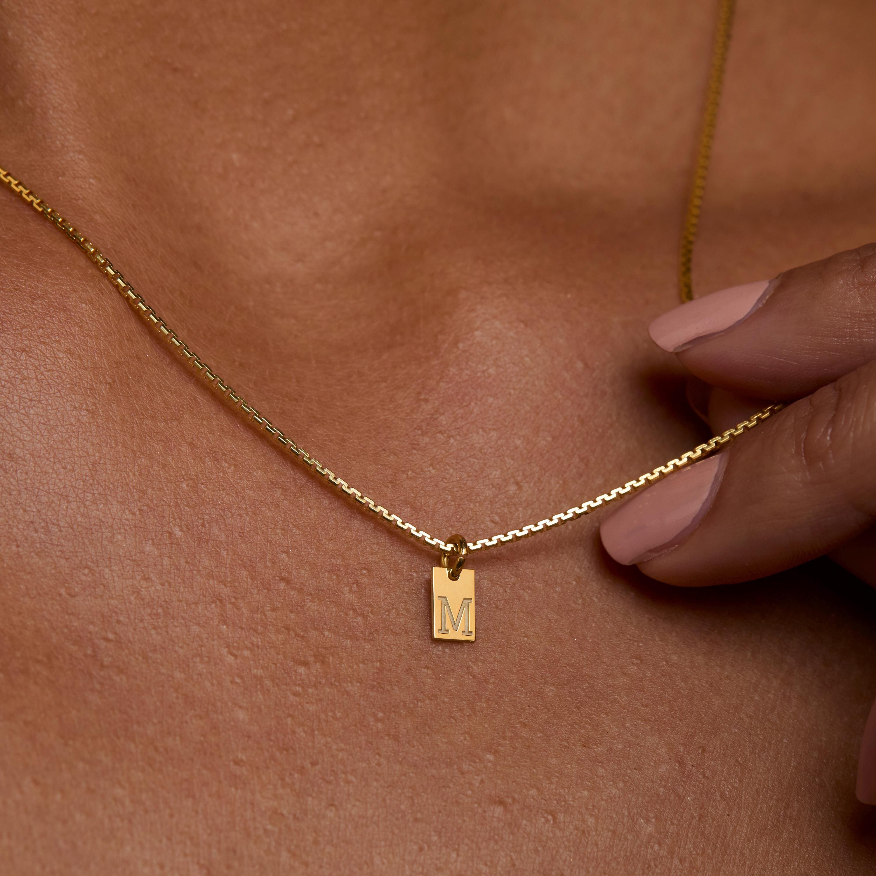 Initial Tag Necklace styled with complementary pieces in 18K Gold Vermeil. Hypoallergenic, no green marks, layered looks.