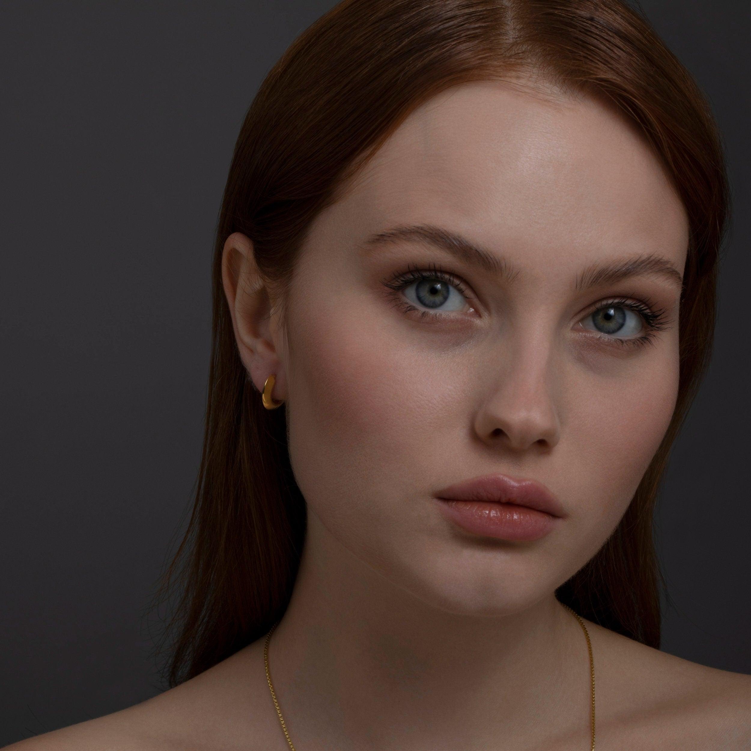 The Knife Edge Huggie Hoop Earring styled in 18K Gold Vermeil — elegant everyday jewelry. Hypoallergenic for sensitive ears.