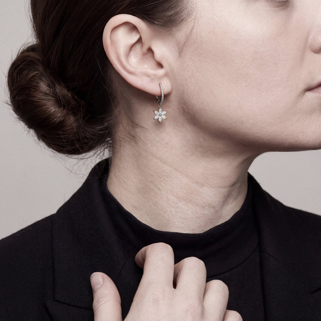Model wearing the marquise diamond flower drop earring, near profile