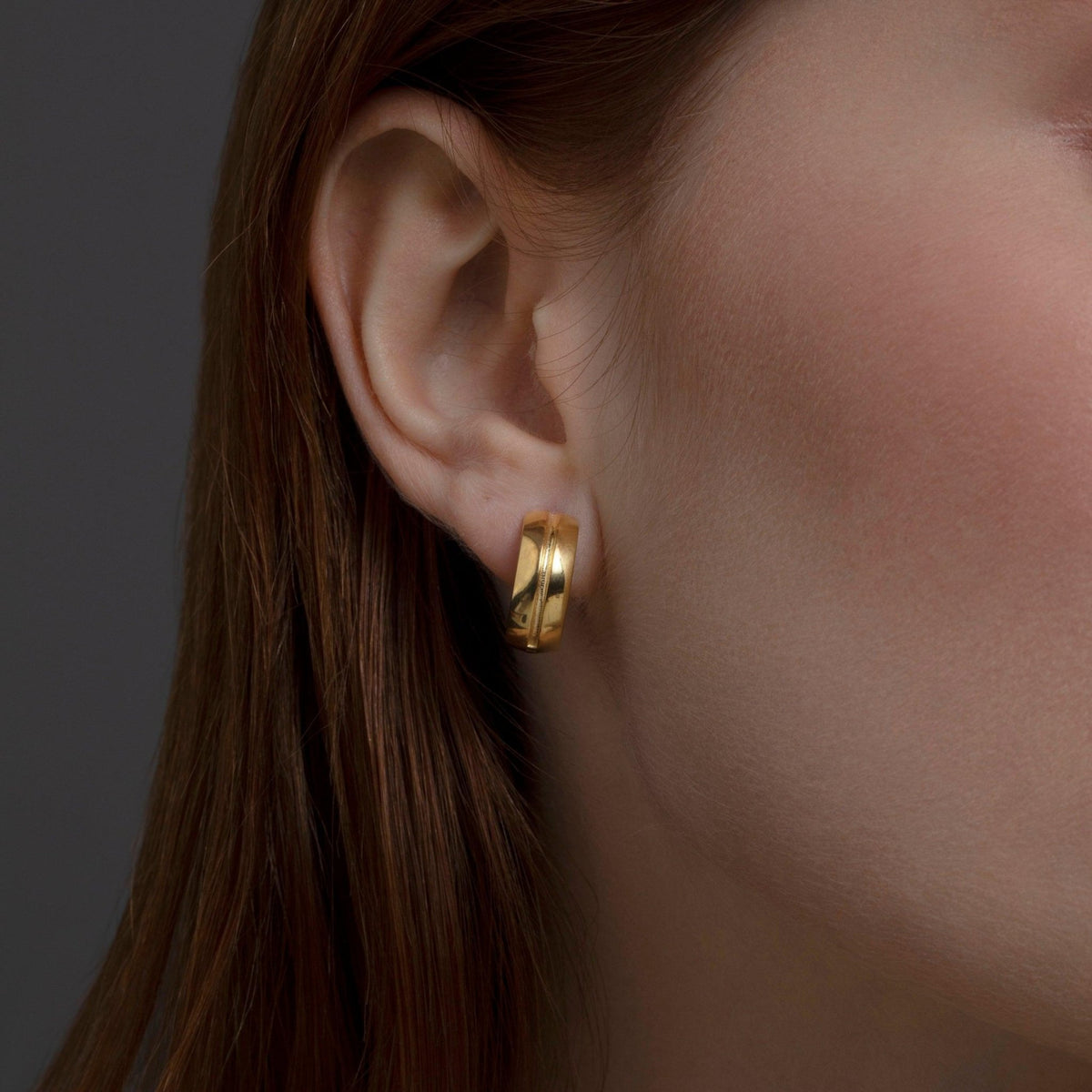 The Modern Huggie Hoop Earrings styled in 18K Gold Vermeil — elegant everyday jewelry. Hypoallergenic for sensitive ears.