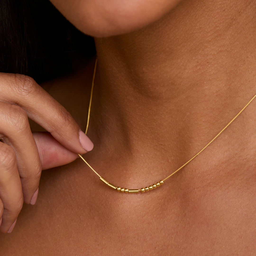 Close detail of the Morse Code Necklace in 18K Gold Vermeil. Safe for sensitive skin, premium handmade jewelry.
