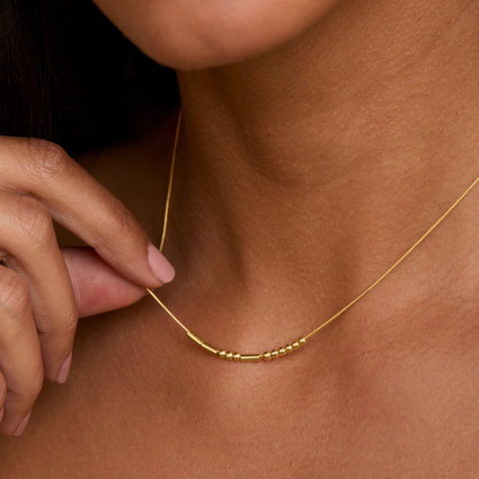 Close detail of the Morse Code Necklace in 18K Gold Vermeil. Safe for sensitive skin, premium handmade jewelry.