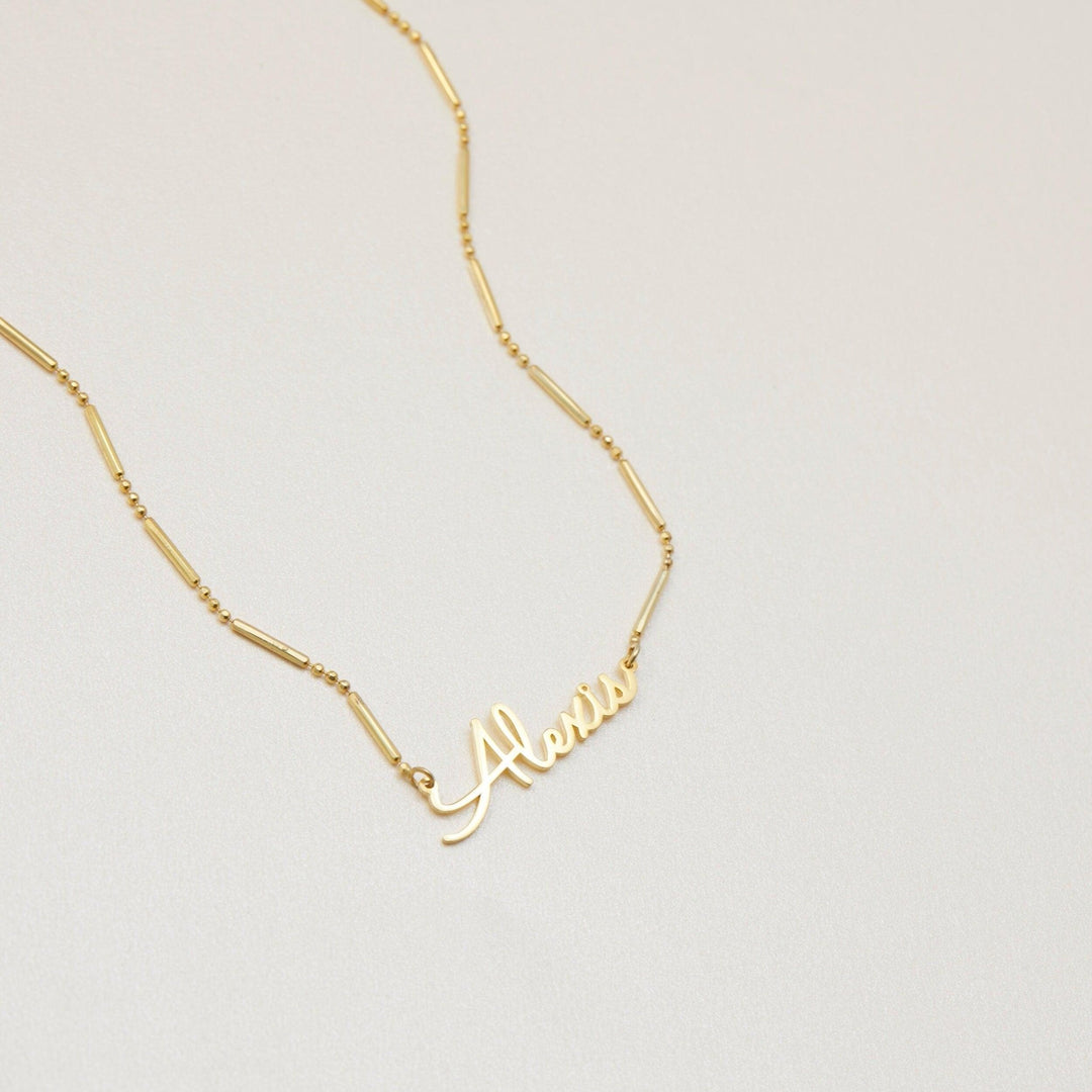 Name Necklace with Italian Chain styled with complementary pieces in 18K Gold Vermeil. Hypoallergenic, no green marks.