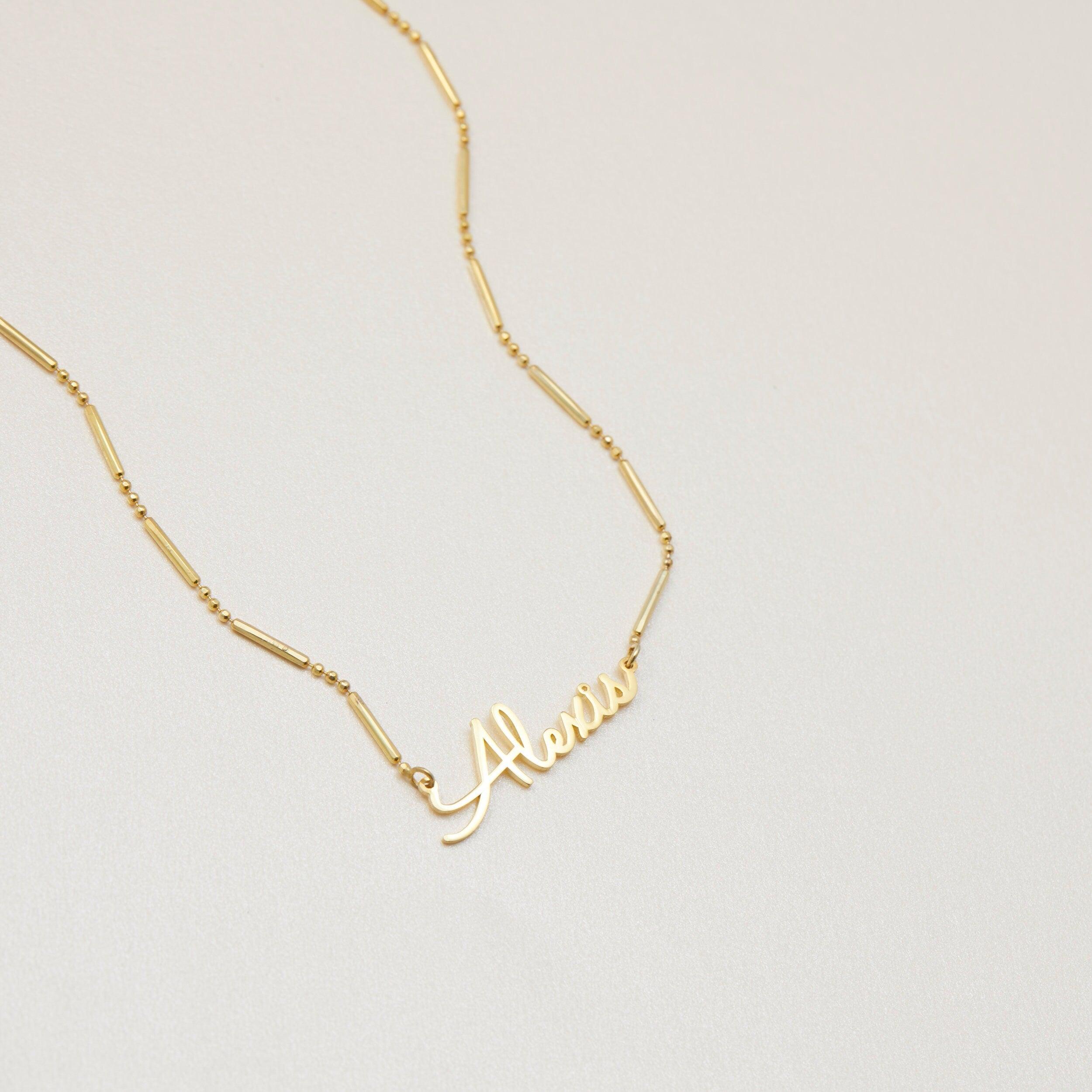 Name Necklace with Italian Chain styled with complementary pieces in 18K Gold Vermeil. Hypoallergenic, no green marks.