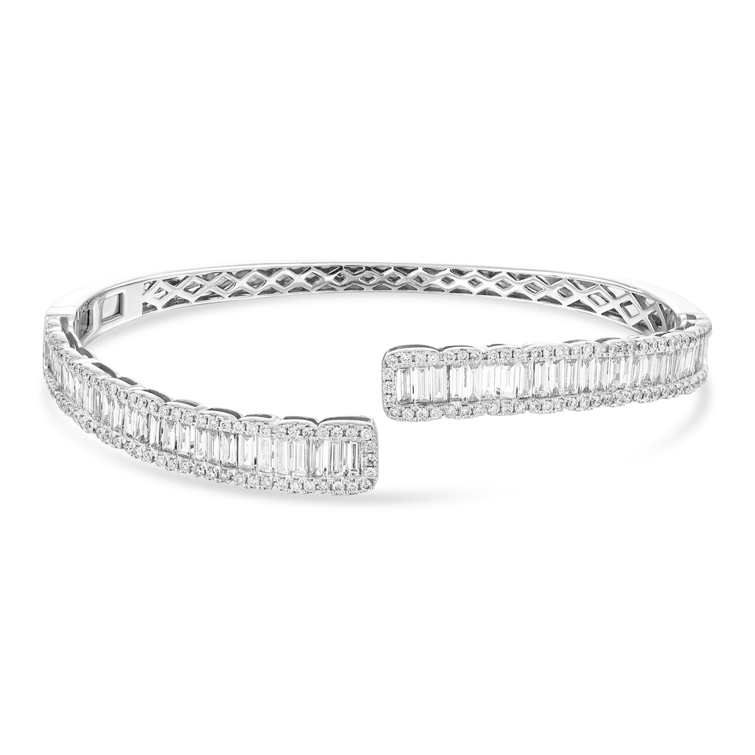 Natural diamond baguette bypass cuff in 18K white gold laid flat, front view on white