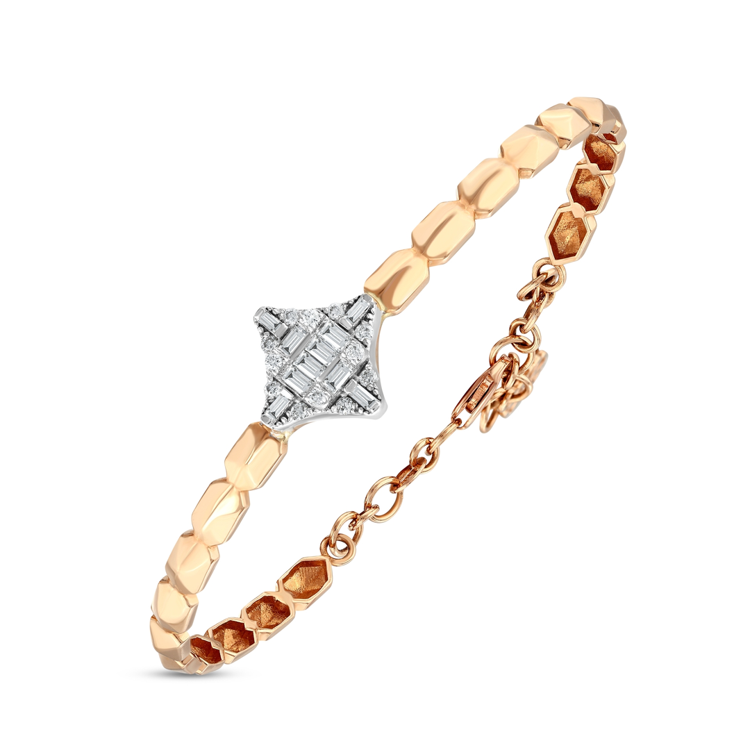Three-quarter view of the natural diamond baguette star bracelet: white-gold star, faceted rose-gold links and lobster clasp