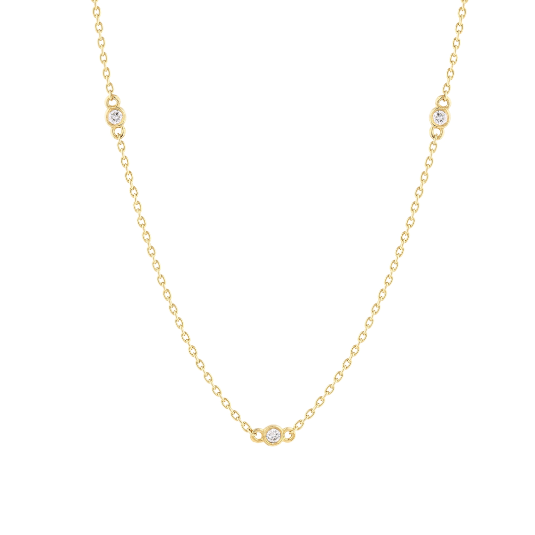 Close-up of the bezel-set natural diamond stations on the 14K yellow gold cable chain