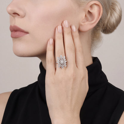 1.59 ct natural diamond flower cocktail ring in 14K white gold worn on the ring finger, palm resting on the cheek, black funnel-neck top
