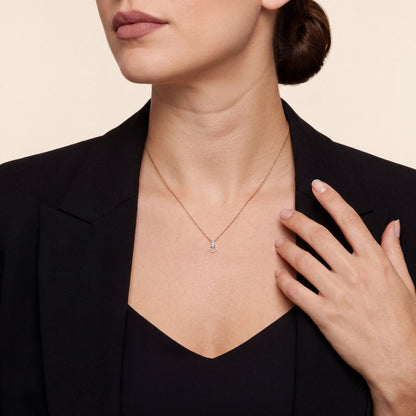 Woman in a black blazer wearing the natural diamond open circle pendant necklace in 18K rose gold