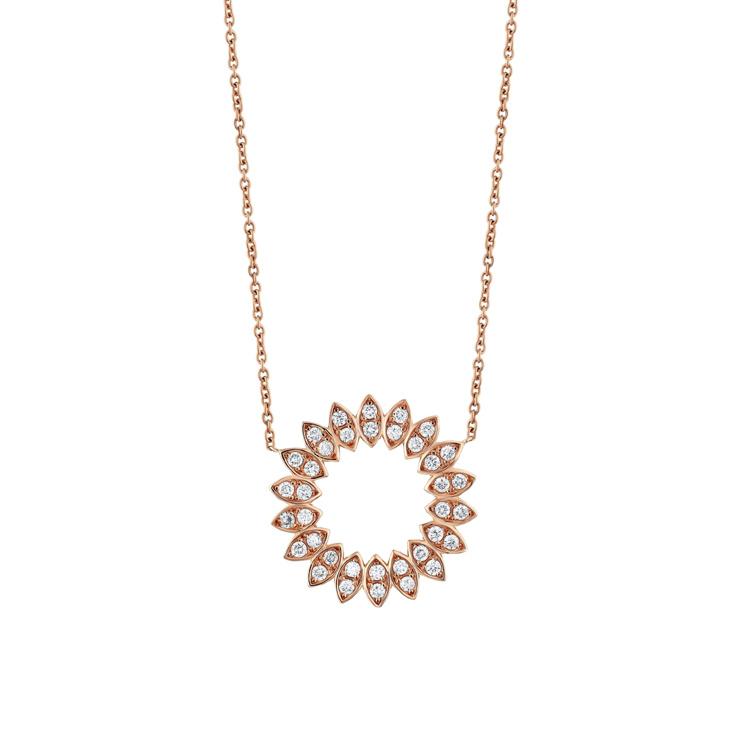 Close view of the eighteen diamond-set petals of a 14K rose gold natural diamond circle pendant.